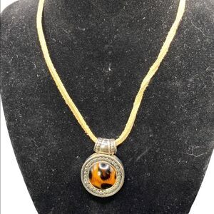 Leopard print silvertone pendant with beaded detail on tan sueded tied strap